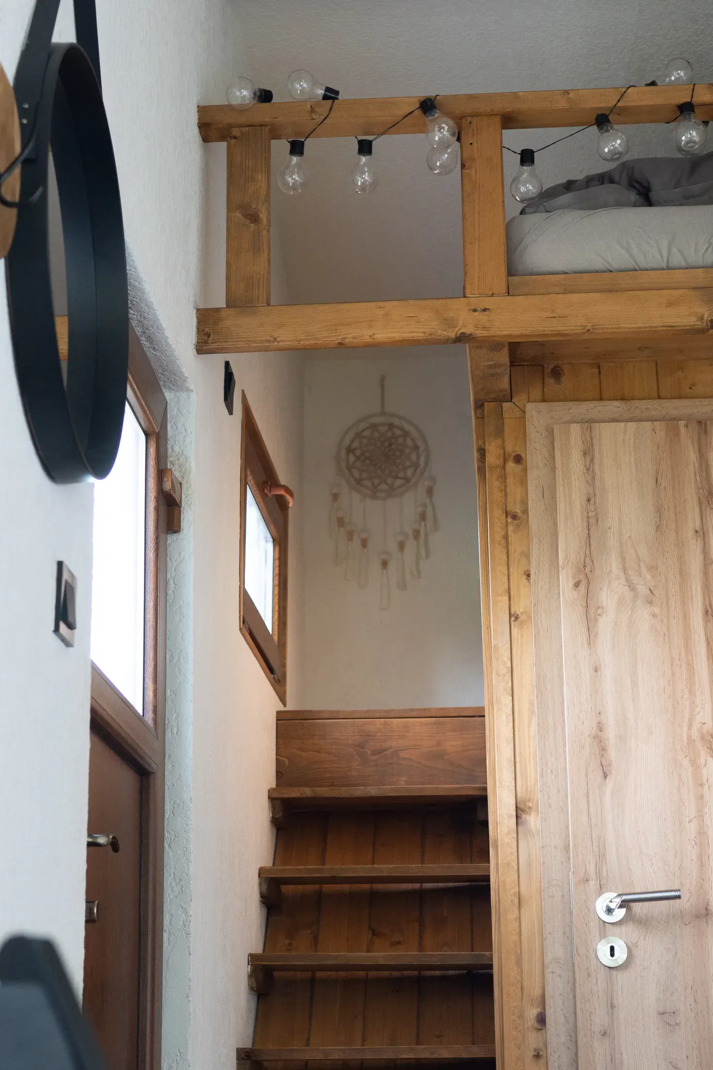 The wagon's entrance area with a bed and a kitchen nook.